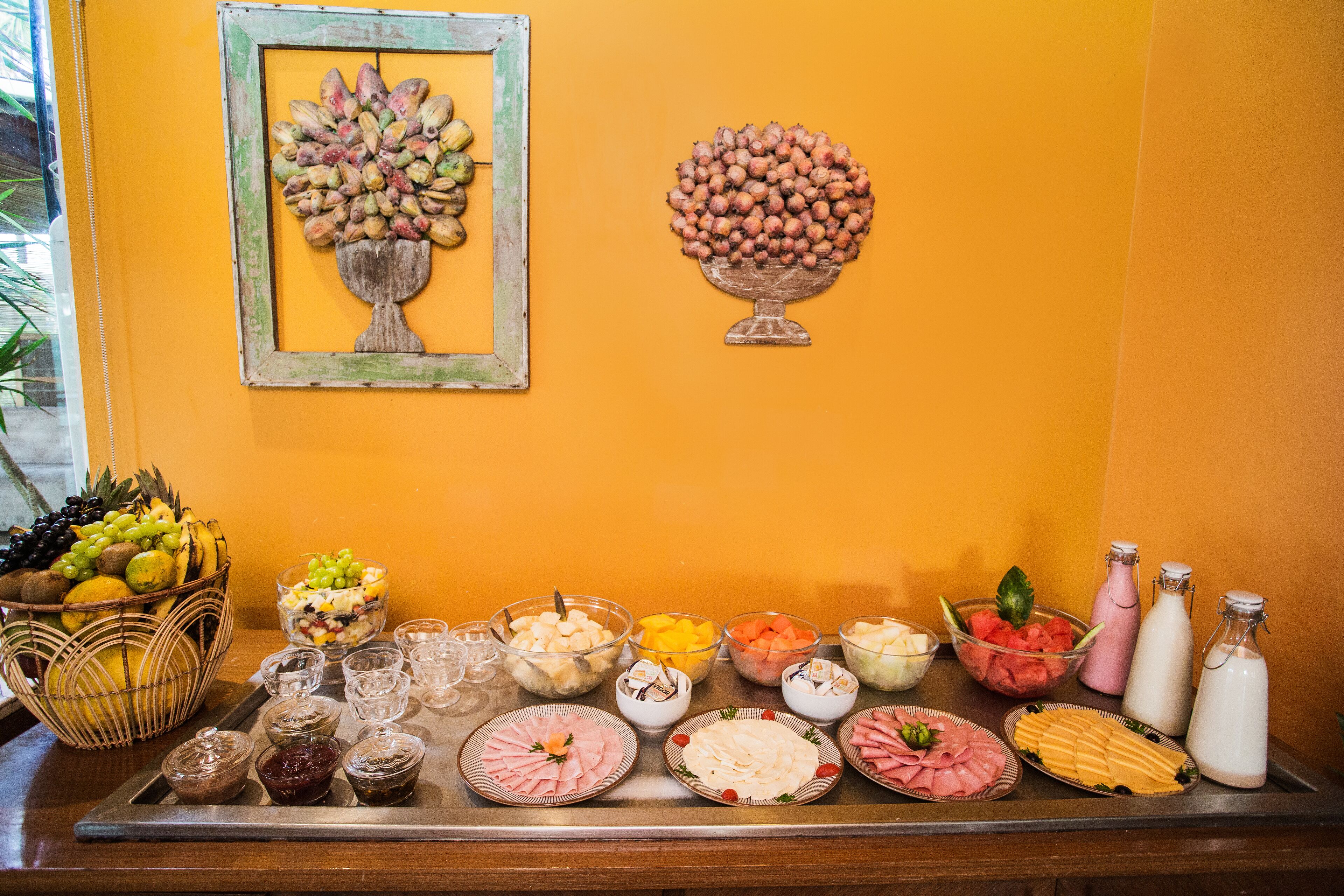 A buffet table with various food items and condiments.
