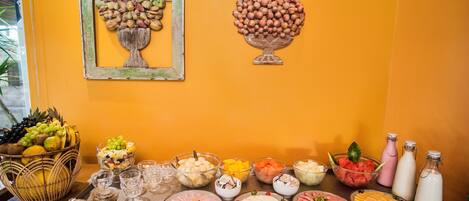 A buffet table with various food items and condiments.
