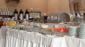 A buffet setup with various food and drink options, including fruits, cereals, and beverages. - Saint Peter Hotel (São José do Rio Preto)