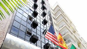 El exterior del Hotel Mengo Palace, con una fachada moderna, amplias ventanas y una entrada destacada.