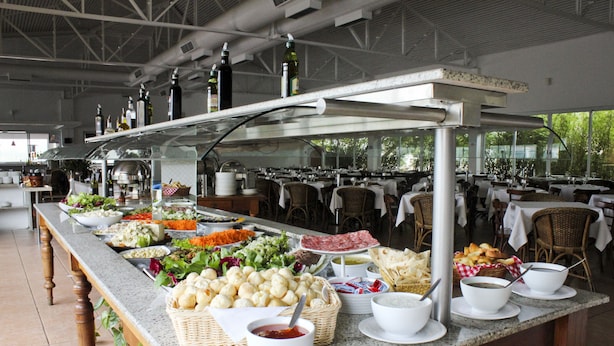 A buffet setup with various food items and beverages.