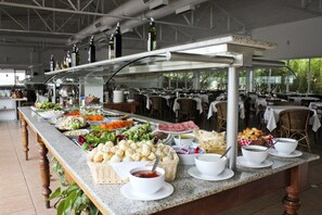 A buffet setup with various food items and beverages.