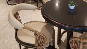 A modern bar area with wicker furniture and a bar counter displaying various bottles. - Hotel Nacional Distributed by Intercity (São José do Rio Preto)