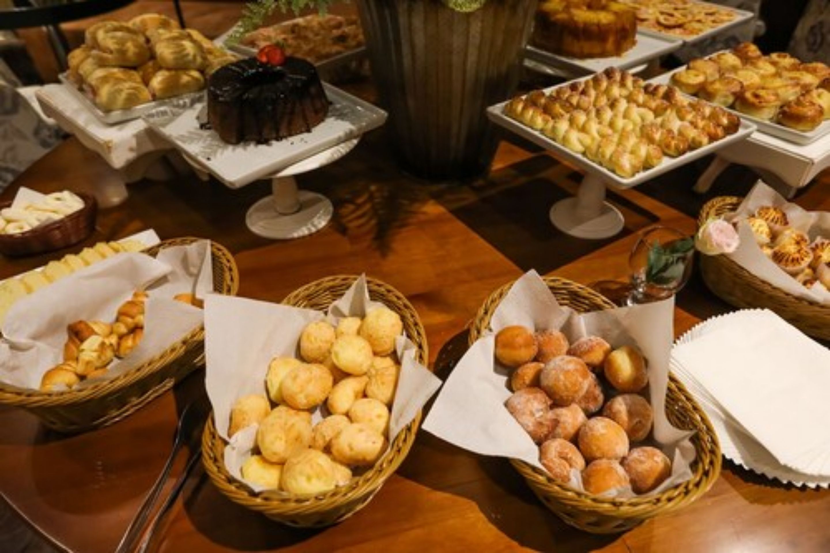 A buffet table with various baked goods and pastries.