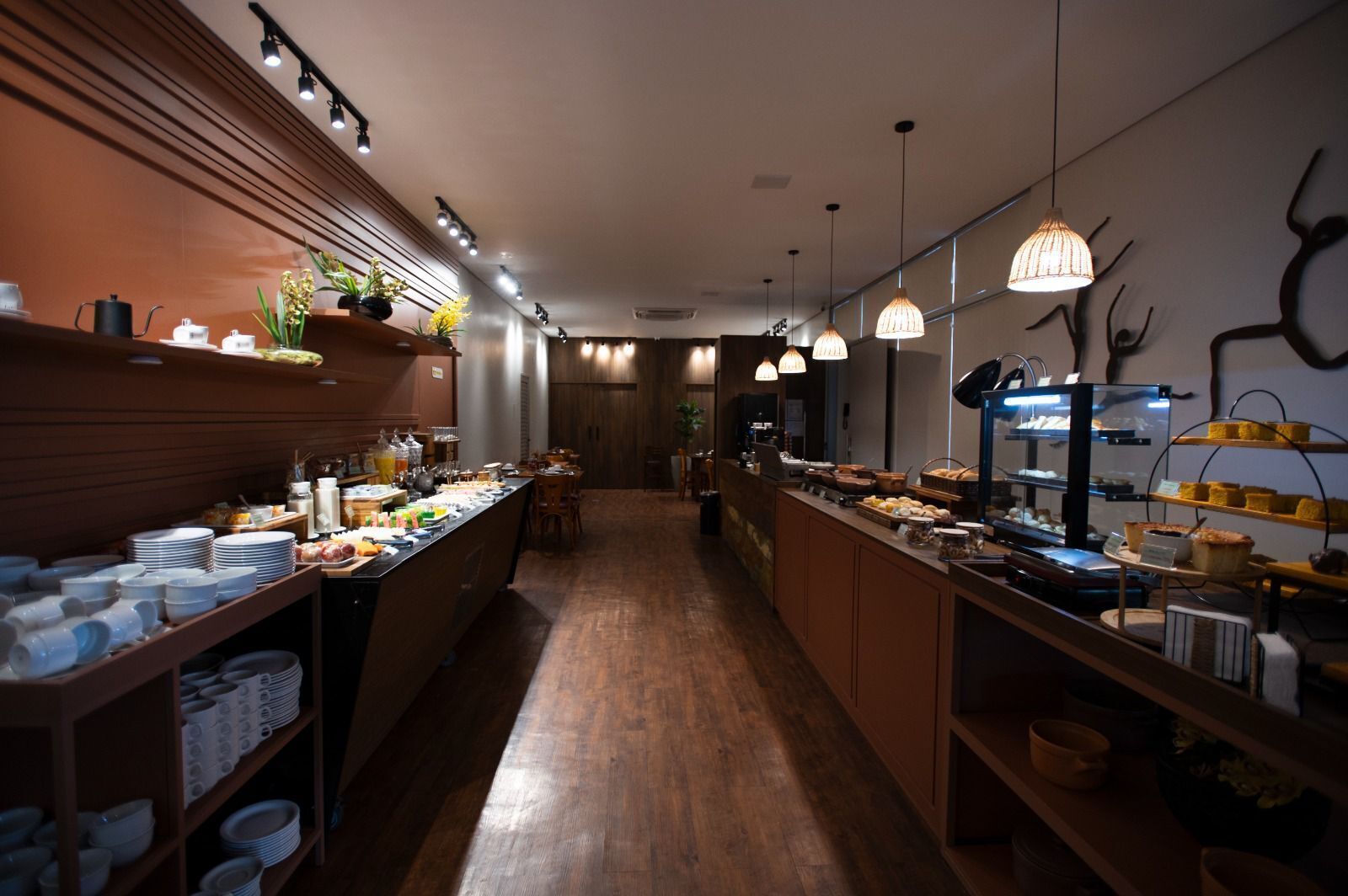 A well-lit buffet area with various food items and dishes displayed on shelves and counters.