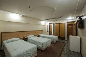 Standard Triple Room | Minibar, in-room safe, desk, blackout drapes
