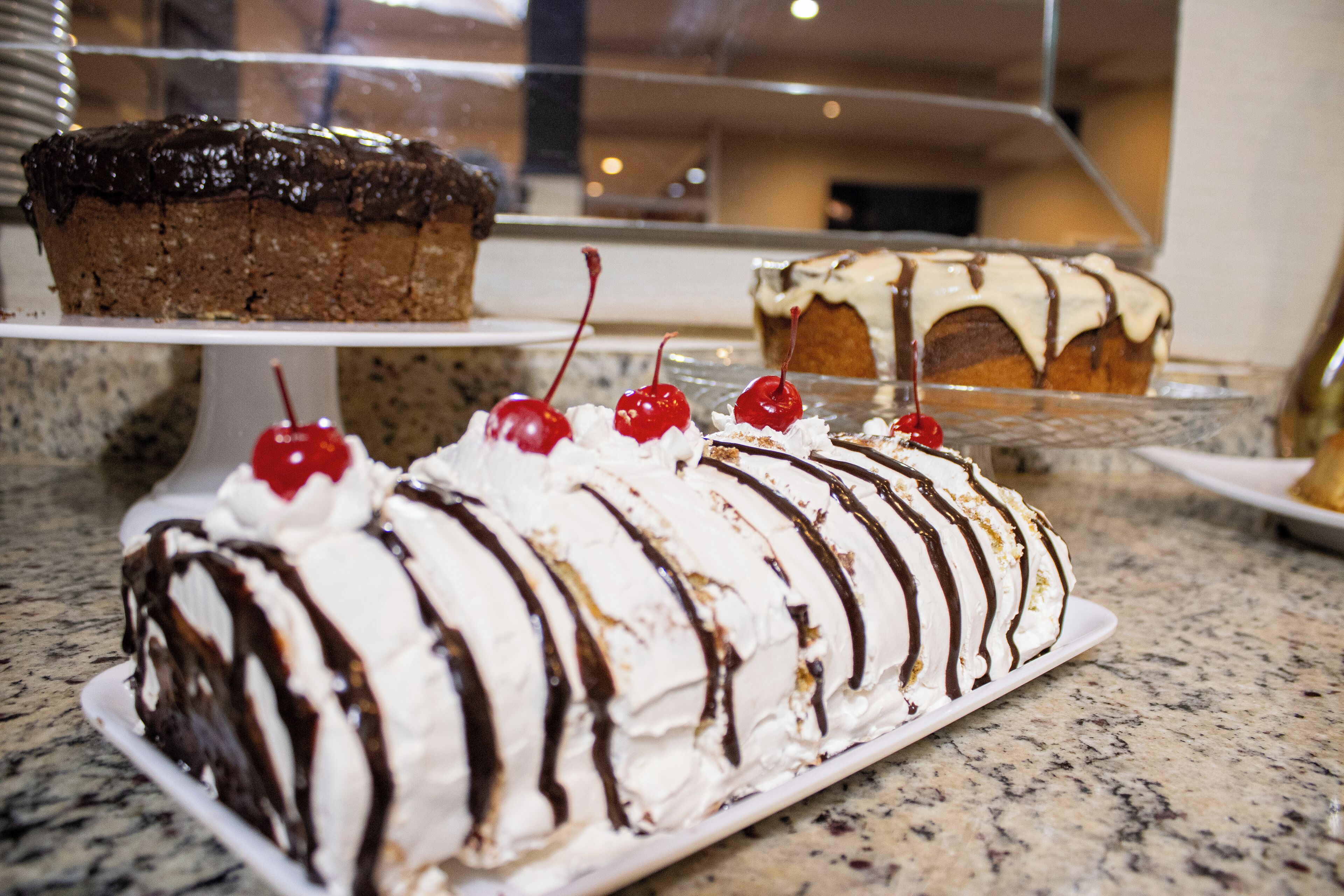 A dessert display with various cakes and pastries.