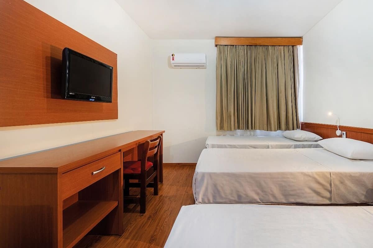 Standard Triple Room | Minibar, in-room safe, desk, blackout drapes