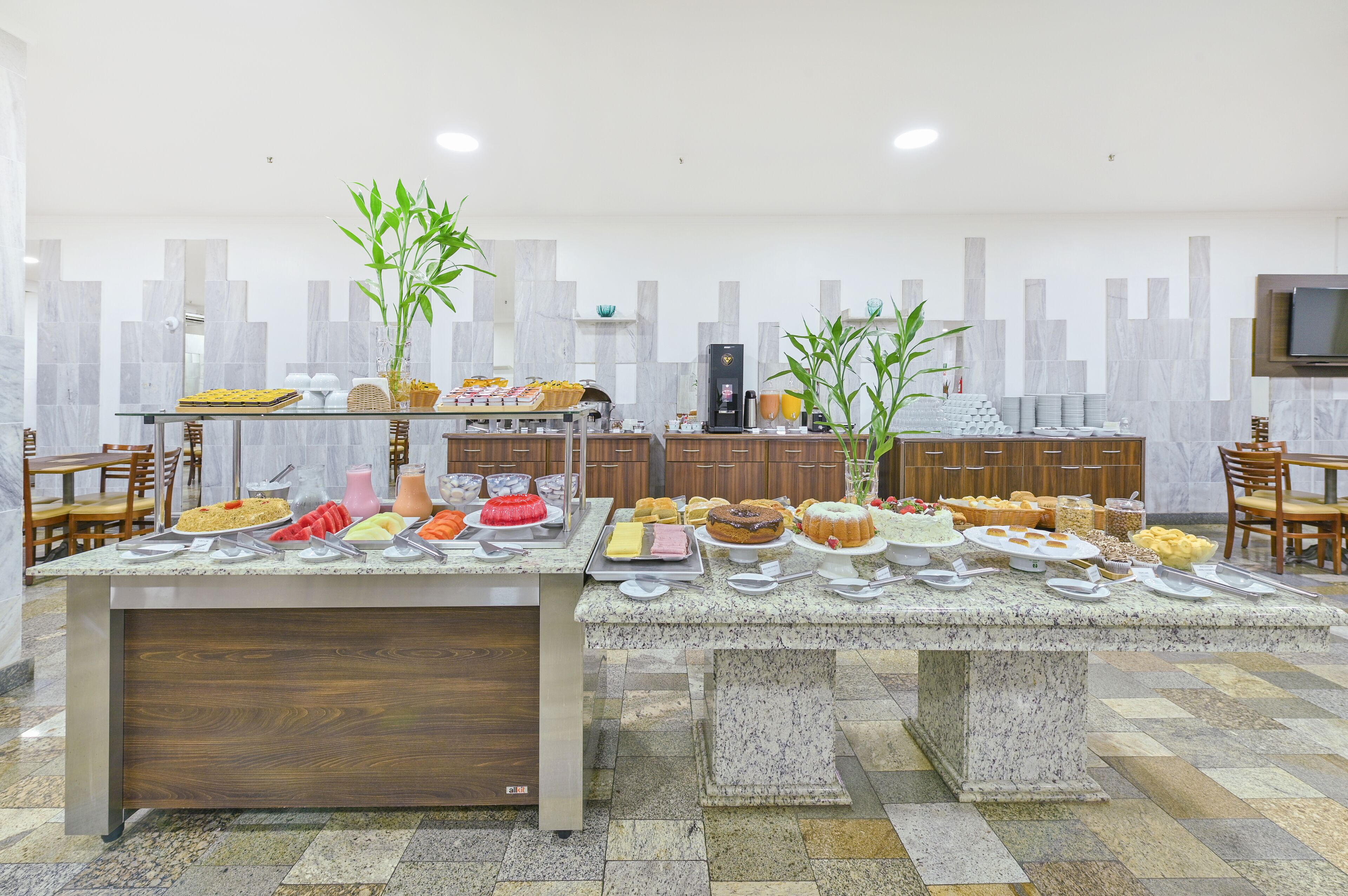 A buffet with various food items and a coffee station.