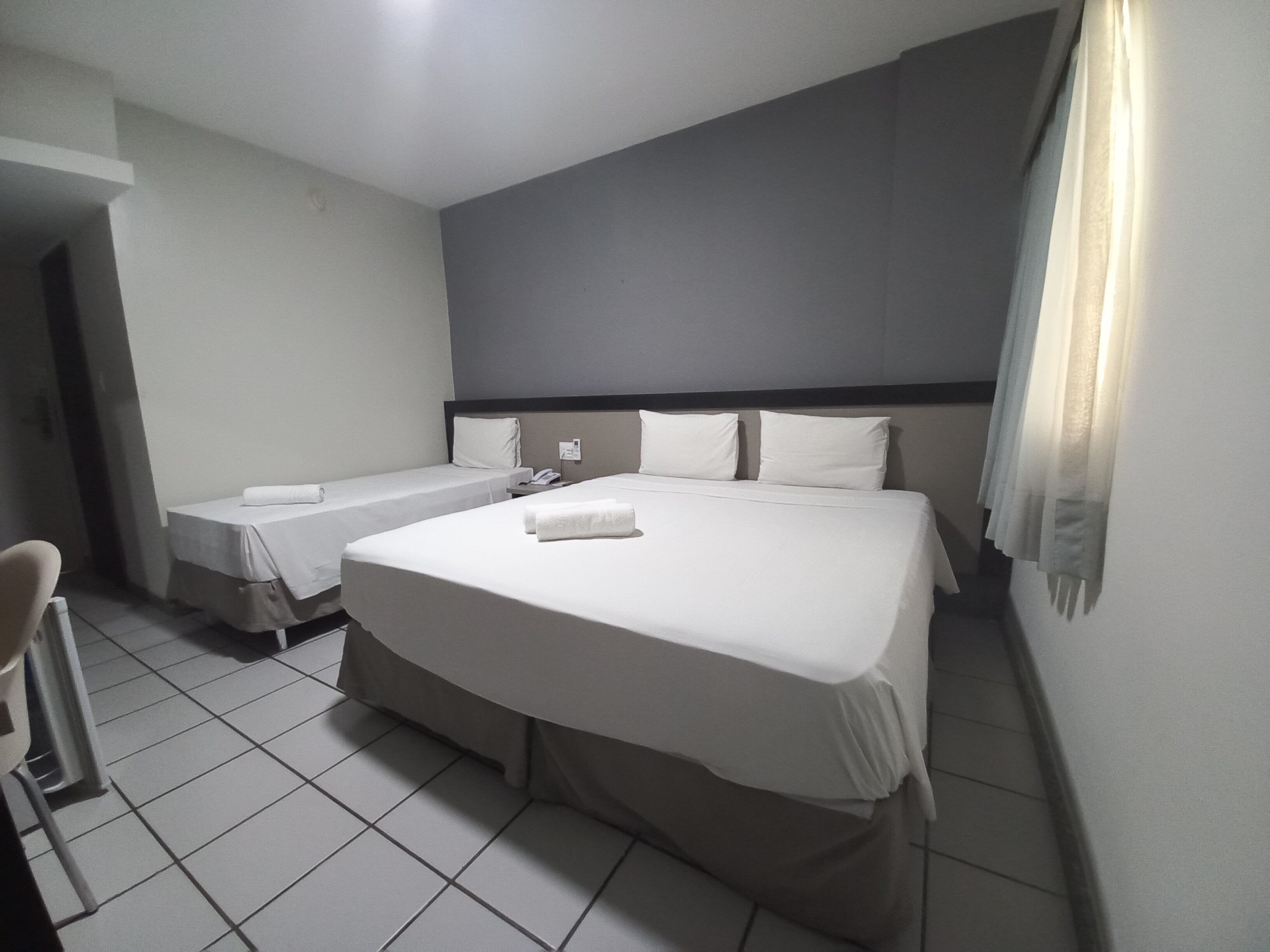 standard triple room | 1 bedroom, in-room safe, desk, blackout curtains