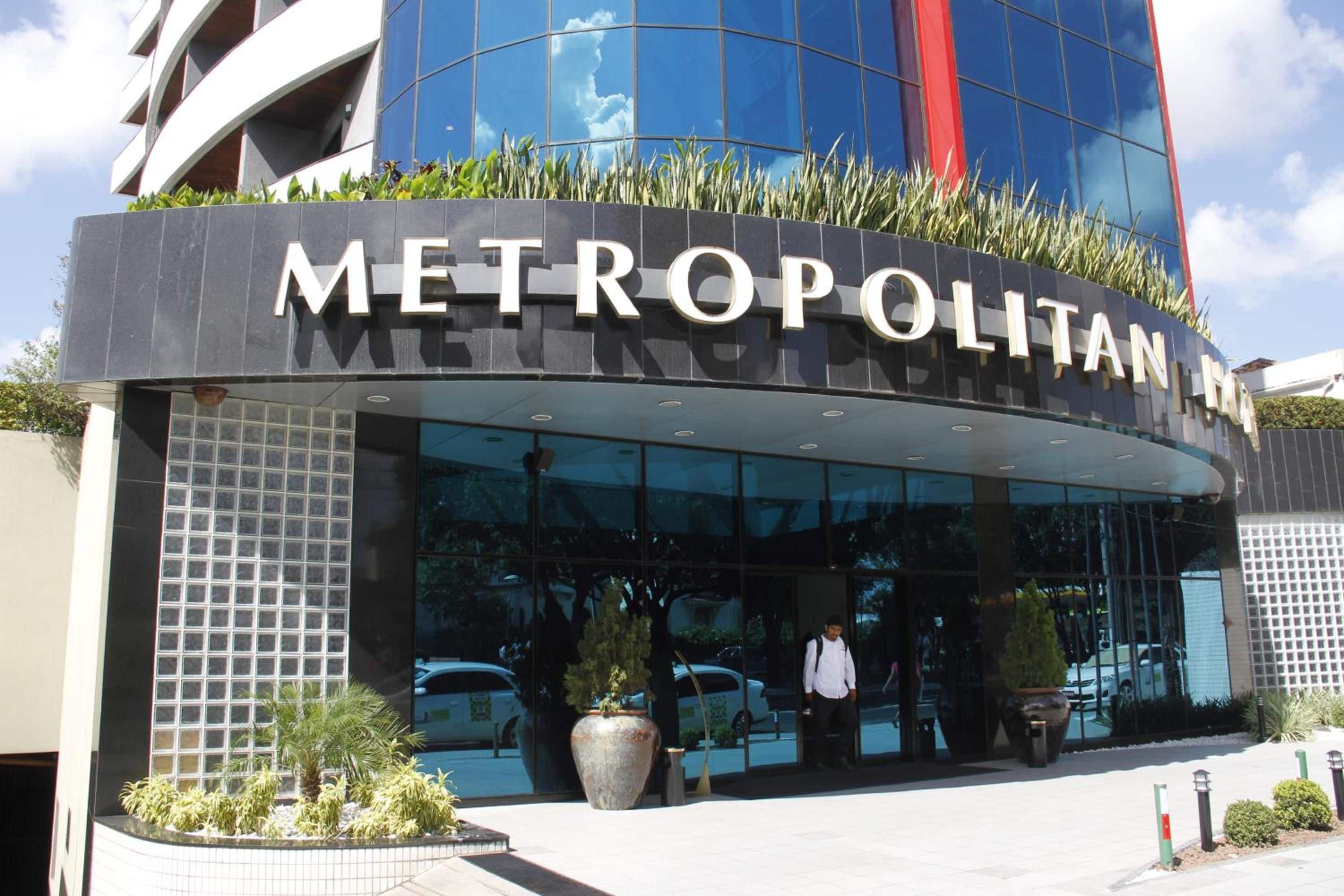 A modern building with a large glass entrance and the words 'METROPOLITAN' prominently displayed.
