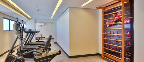 A gym with treadmills, an elliptical, and a pull-up bar.