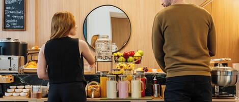 A breakfast buffet with various food items and a coffee station.