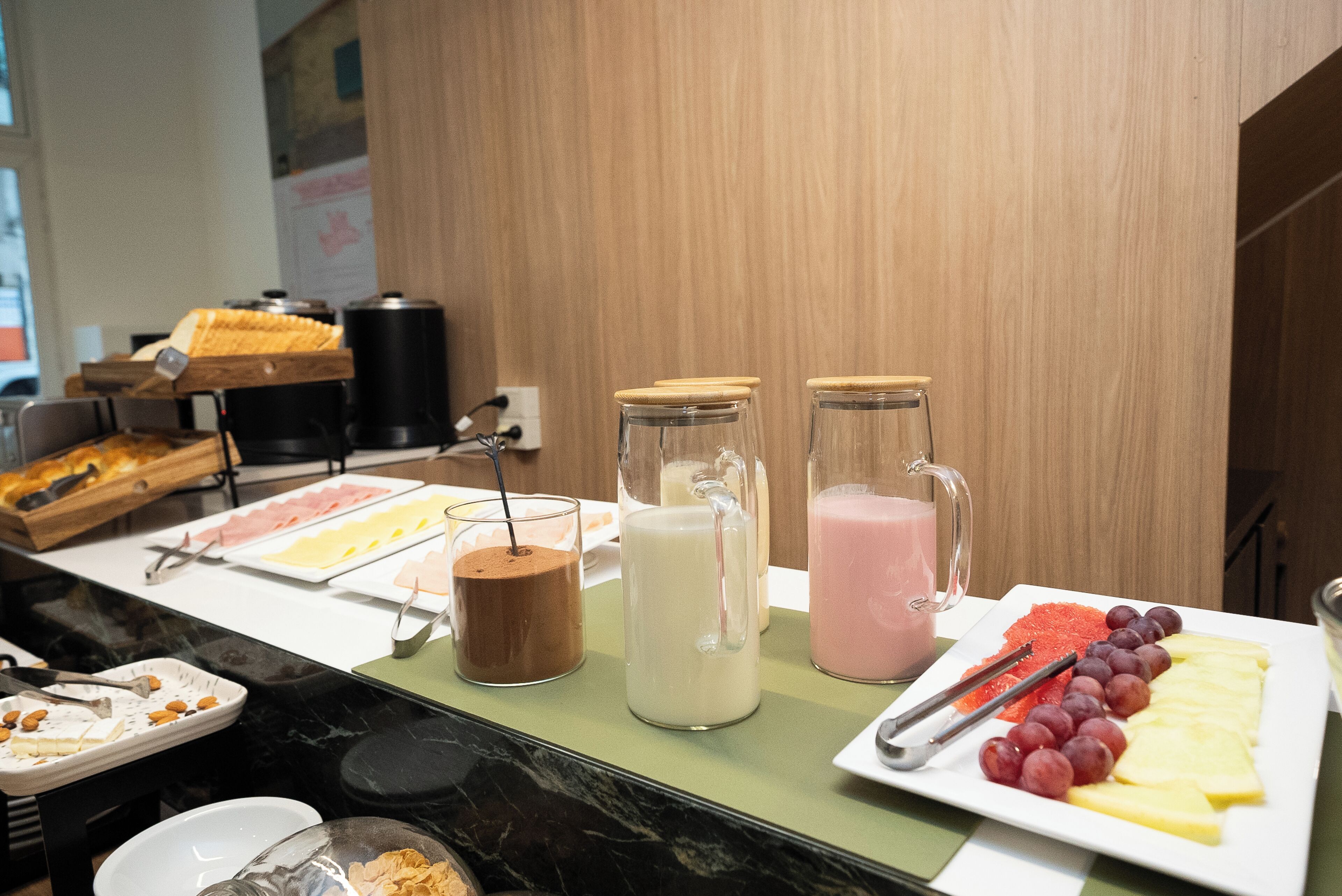 A buffet setup with various food items and beverages.