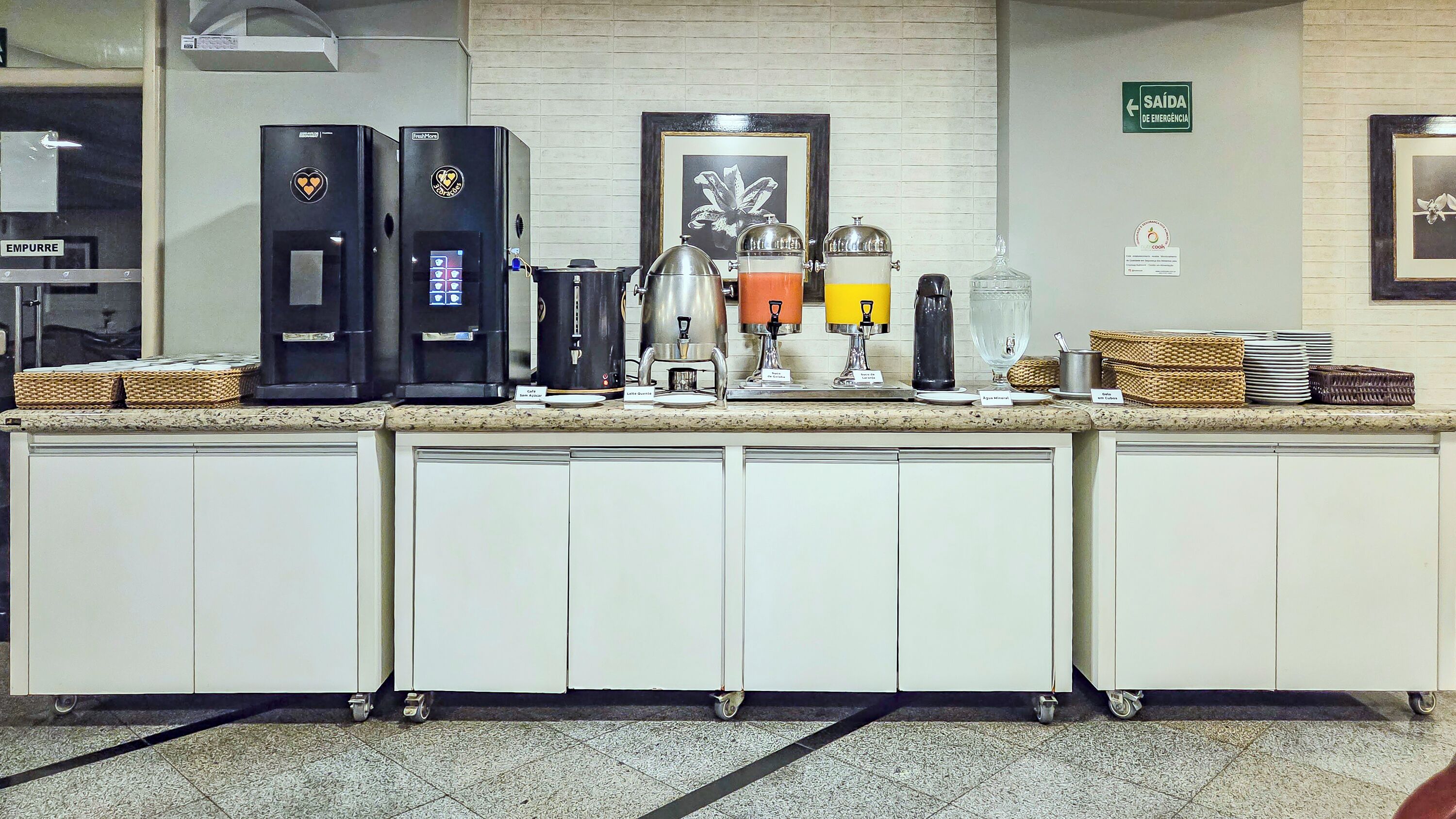 A self-service coffee station with multiple coffee machines and a water dispenser.