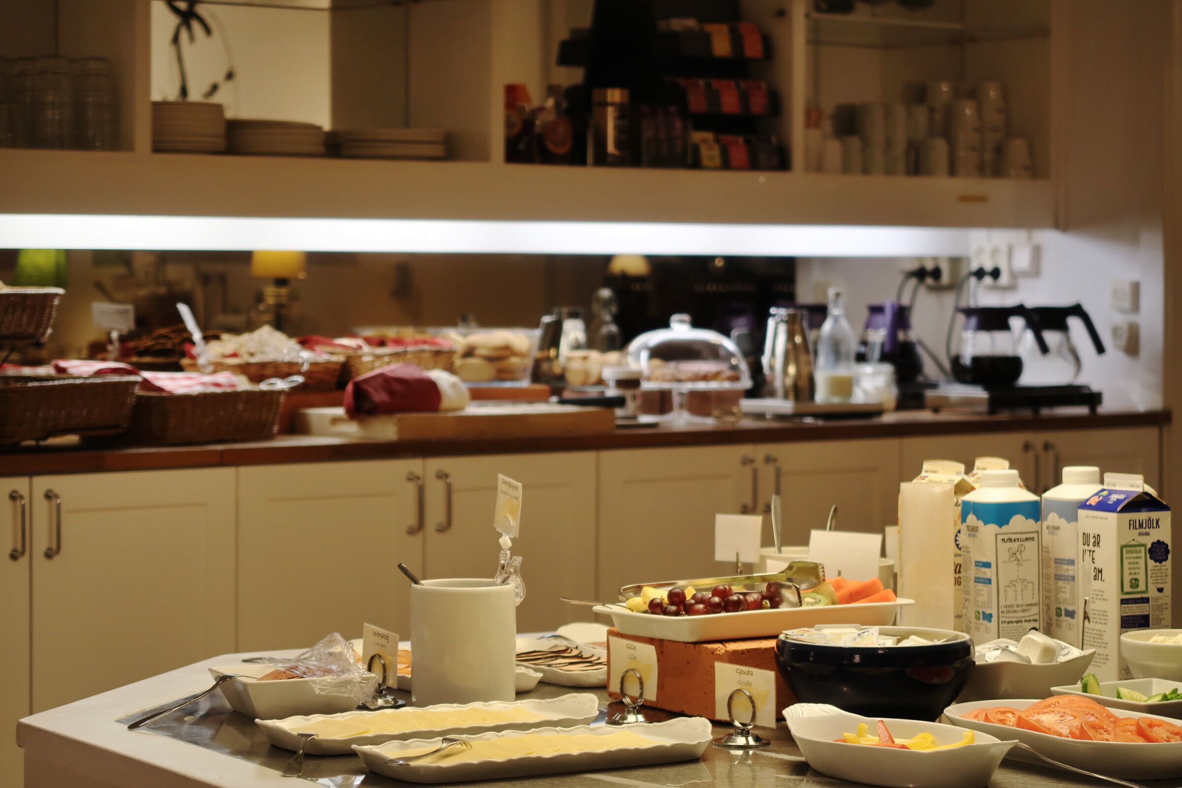 A buffet setup with various food items and beverages.
