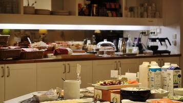 A buffet setup with various food items and beverages.