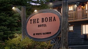 A wooden sign for The Boha Hotel by White Rainbow. - The Boha Hotel (Lake Placid)