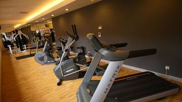 A gym with treadmills and elliptical machines.