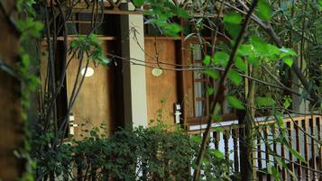 A wooden building with a balcony and a door marked with the number 210.