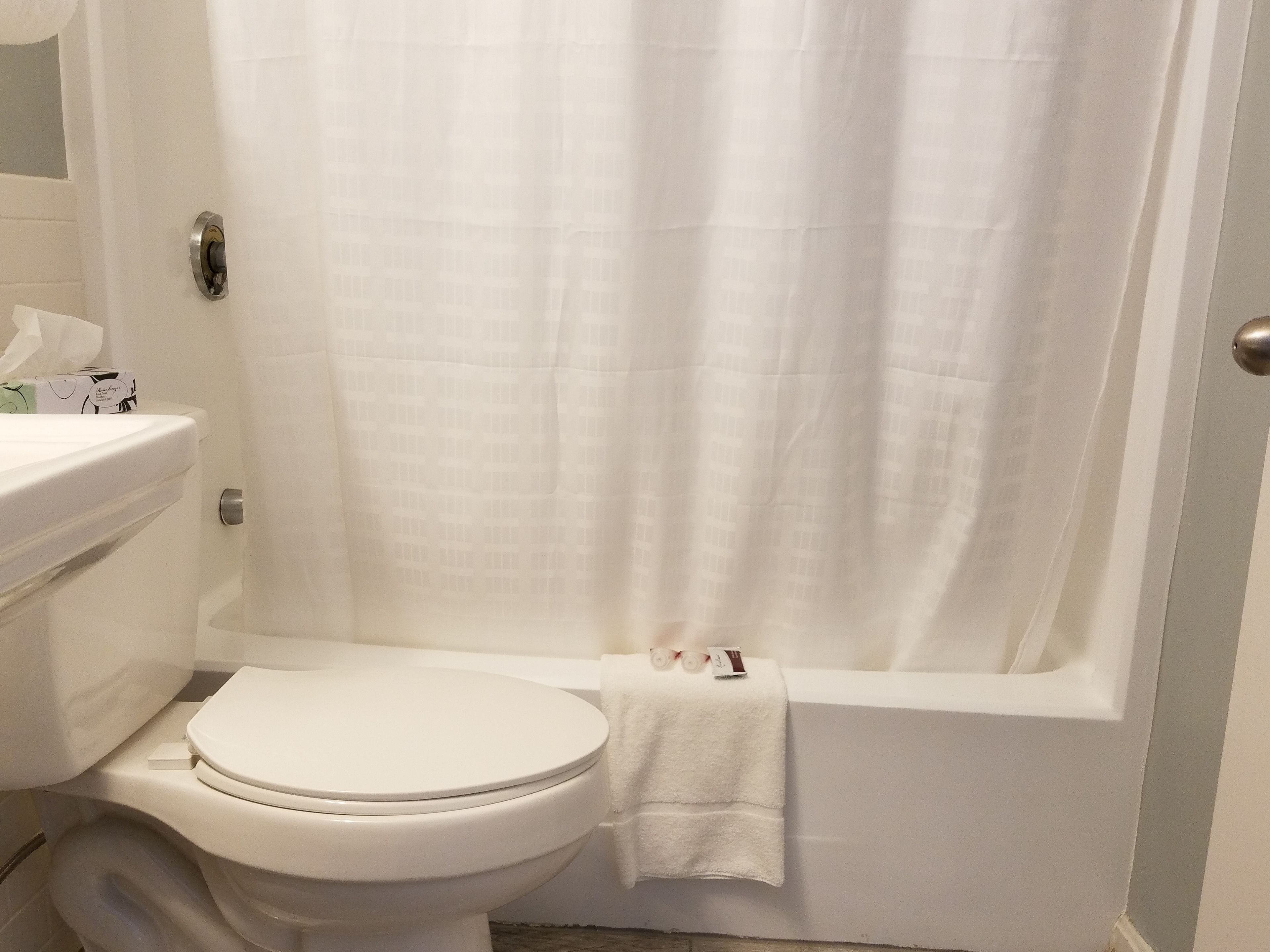 A bathroom with a toilet, a sink, and a bathtub.