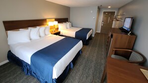 A hotel room with two beds, a desk with a computer, and a chair. - Hampton Village Inn (Hampton)