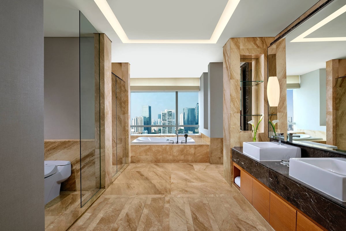 club suite, 1 king bed, city view | bathroom | separate bathtub and shower, designer toiletries, hair dryer, bathrobes