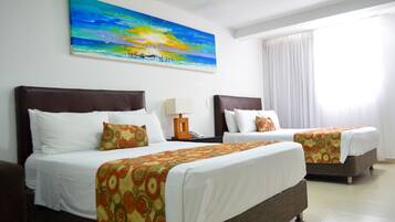 Standard Quadruple Room | In-room safe, desk, laptop workspace, iron/ironing board