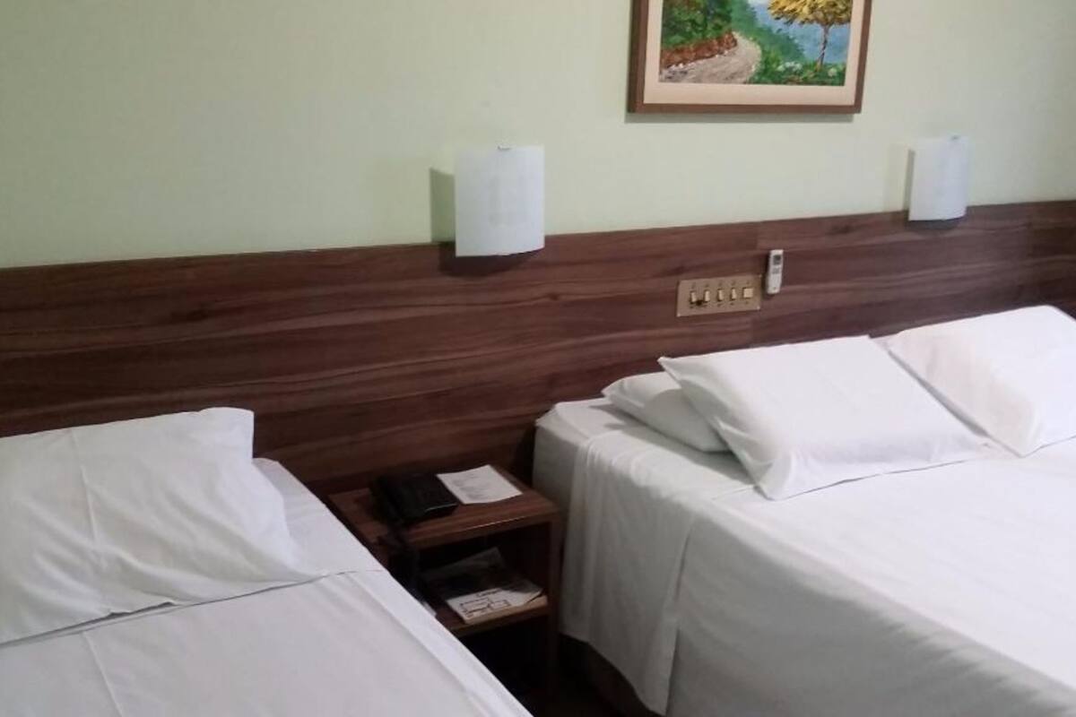 Deluxe Triple Room | Minibar, in-room safe, desk, blackout drapes