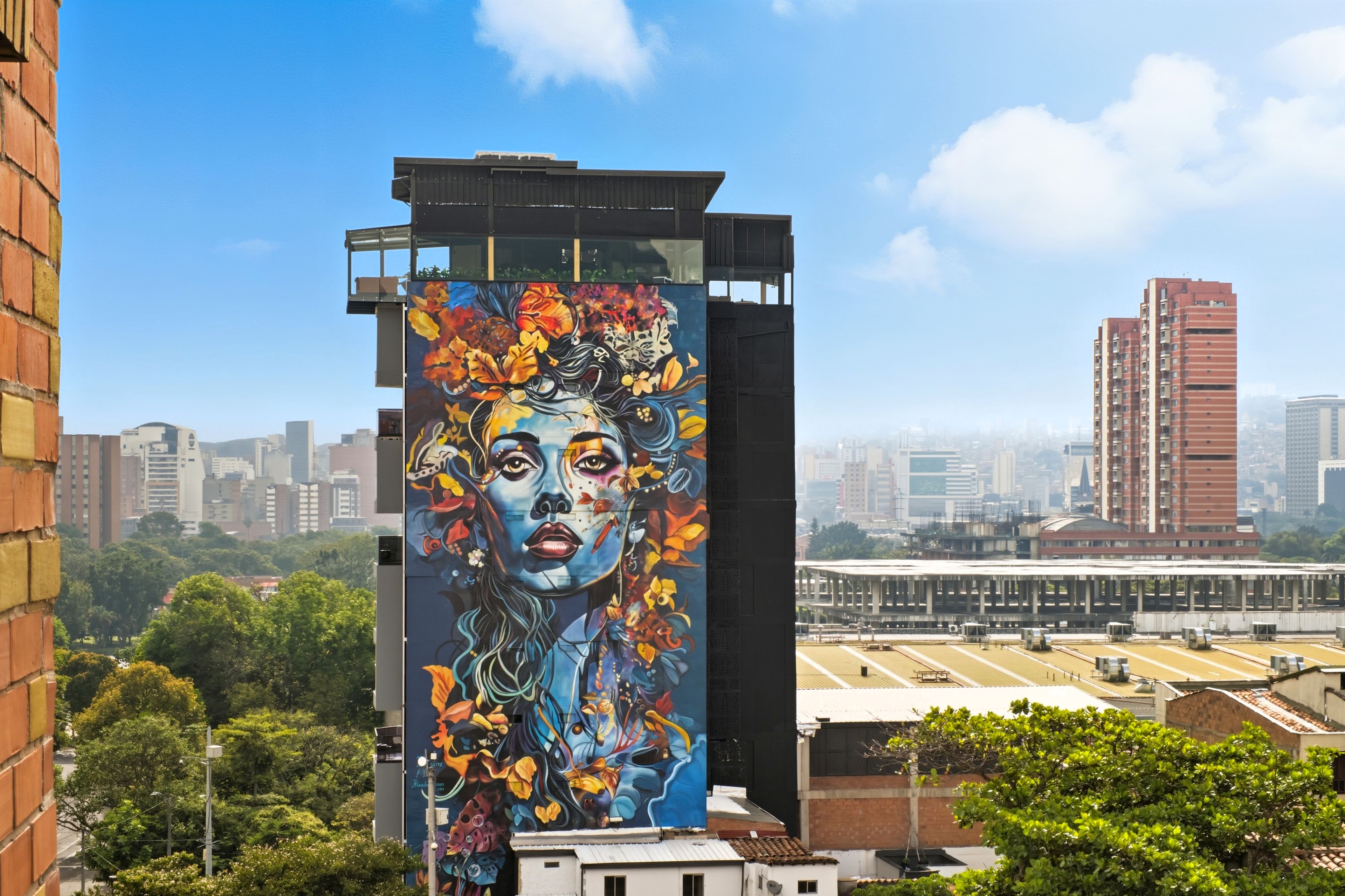 A high-rise building with a large mural on its side.