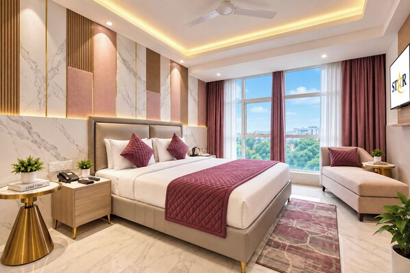 A modern hotel room with a large bed, a sofa, a desk, and a view of the city. - Hotel International Inn (New Delhi)