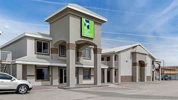 A hotel with a modern architectural design, featuring a prominent sign for Extended Stay America Select Suites.
