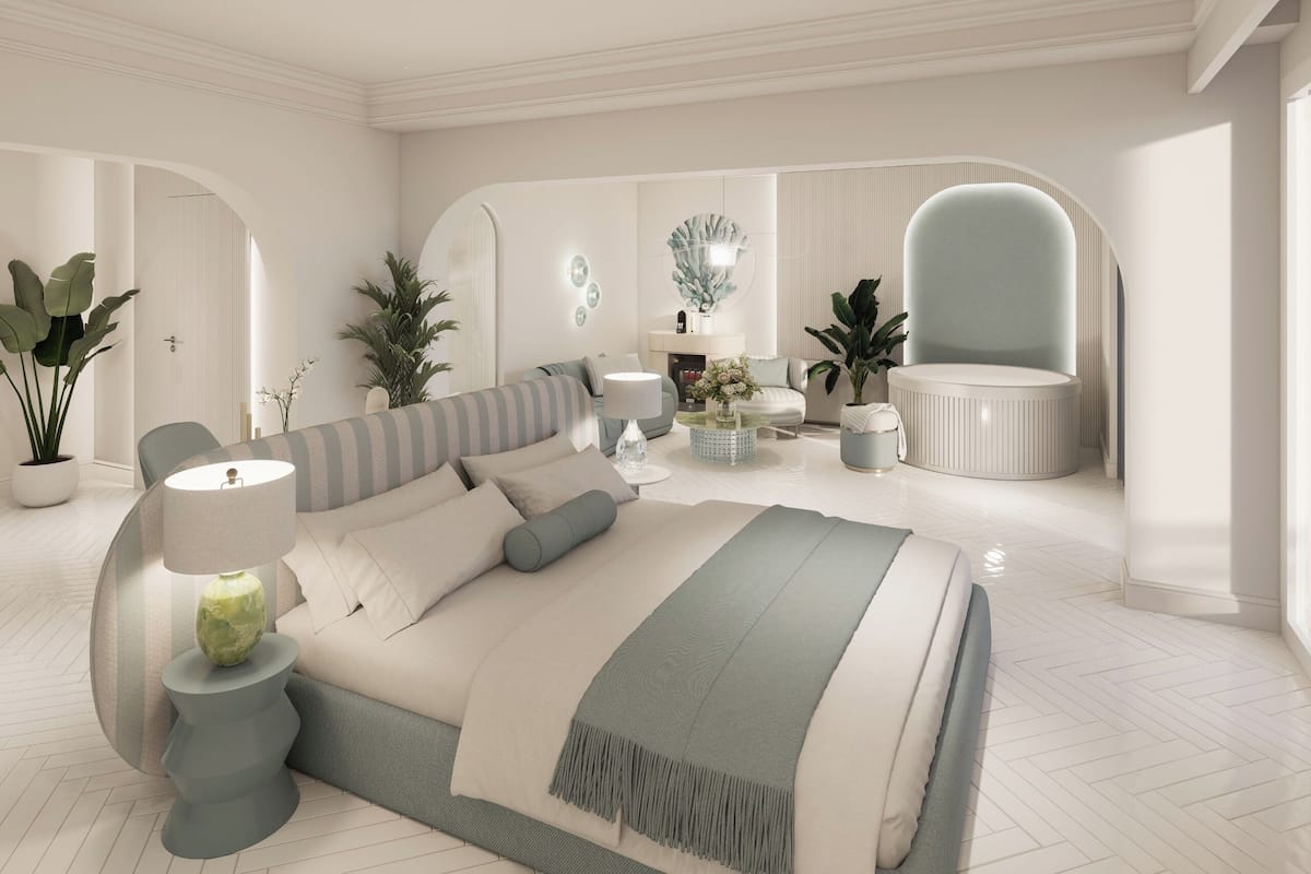 A modern bedroom with a large bed, bedside tables, a chair, and decorative elements.