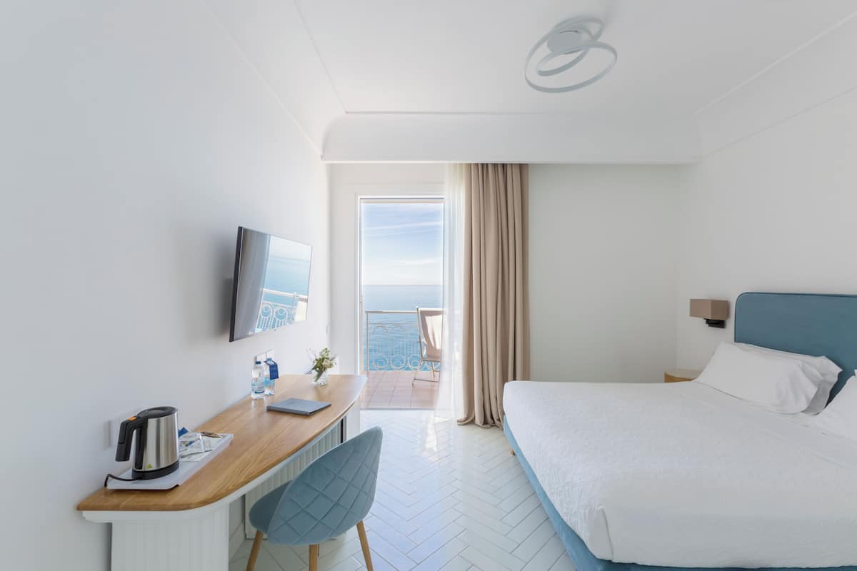 Deluxe Room, Sea View | Minibar, in-room safe, desk, free WiFi