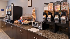 A breakfast bar with coffee machines, a toaster, and various food dispensers.