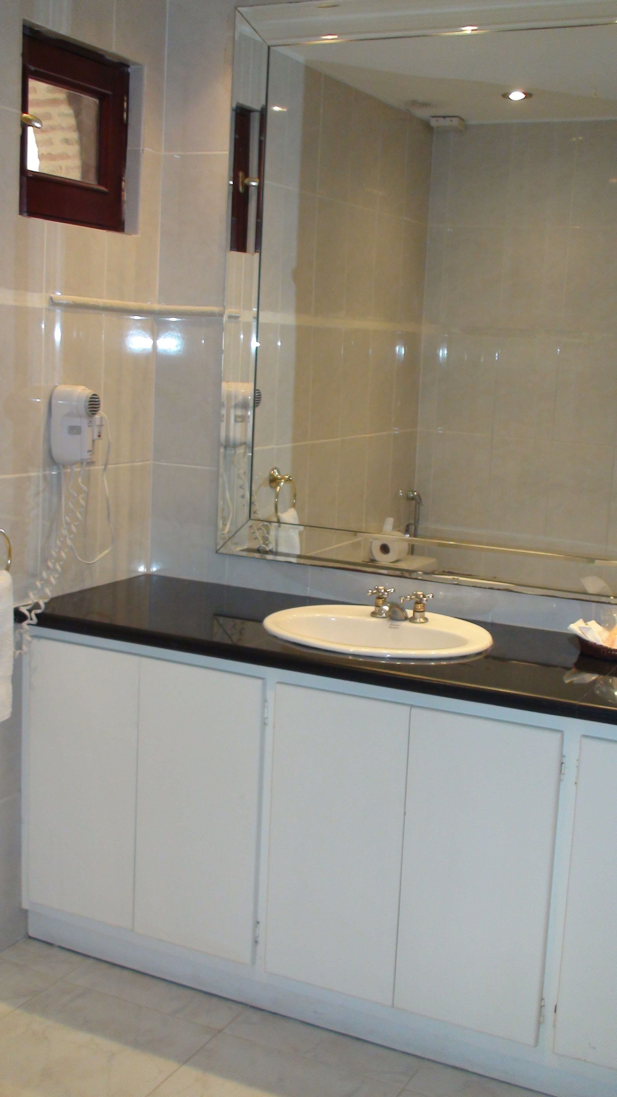 designer toiletries, hair dryer, towels