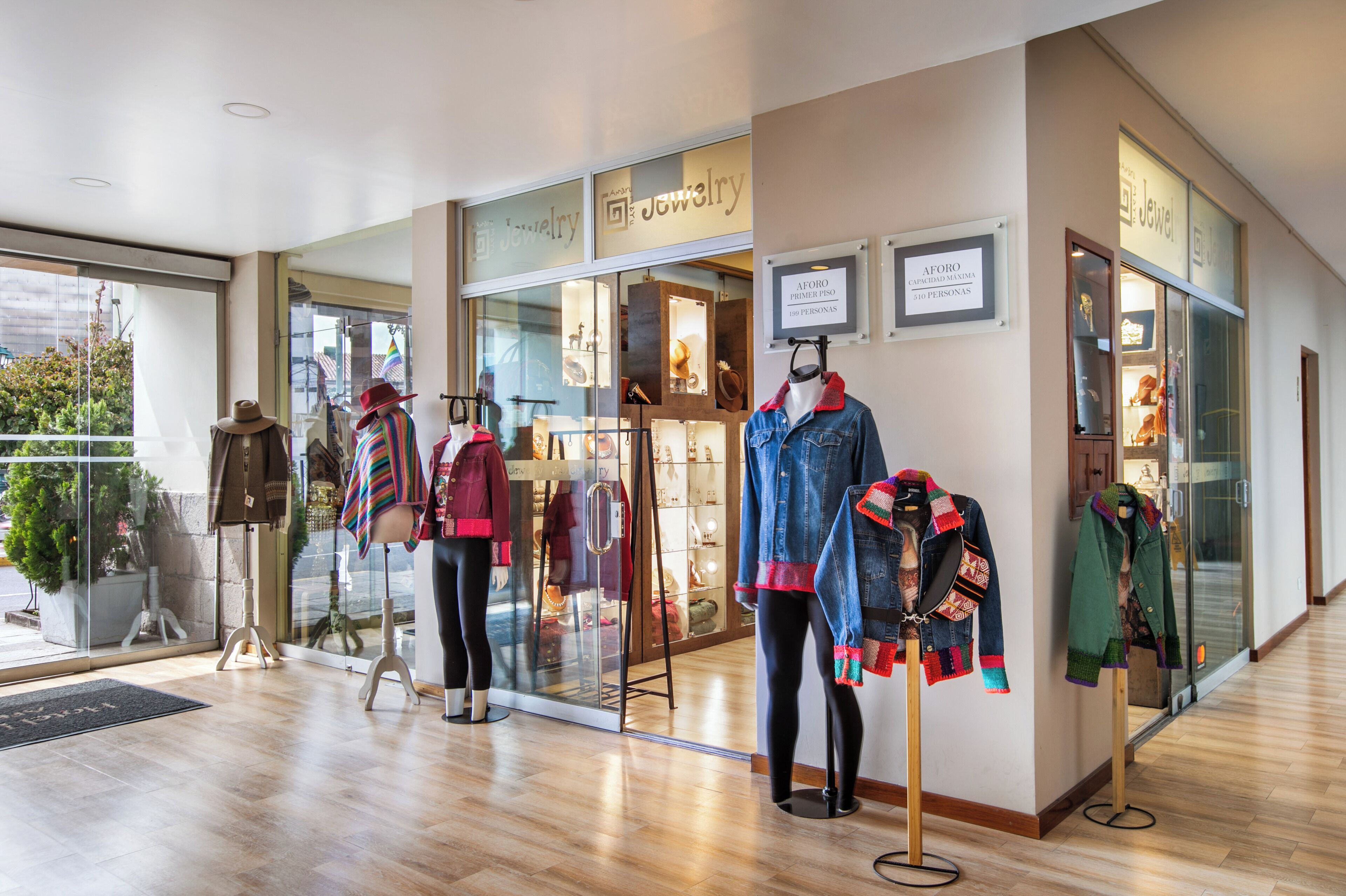 A jewelry store with mannequins displaying various outfits.