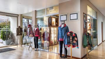 A jewelry store with mannequins displaying various outfits.
