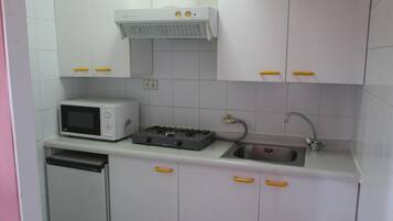 Mini-fridge, coffee/tea maker, cookware/dishes/utensils, paper towels