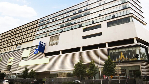 A modern hotel building with multiple floors, large windows, and a prominent 'One Hotels' sign. - One Ciudad de Mexico Patriotismo (Mexico City)