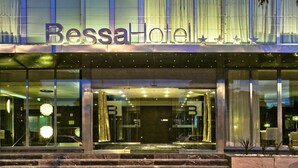The exterior of Bessa Hotel with a glass facade, a marble entrance, and a star decoration above the entrance. - BessaHotel Boavista (Porto)