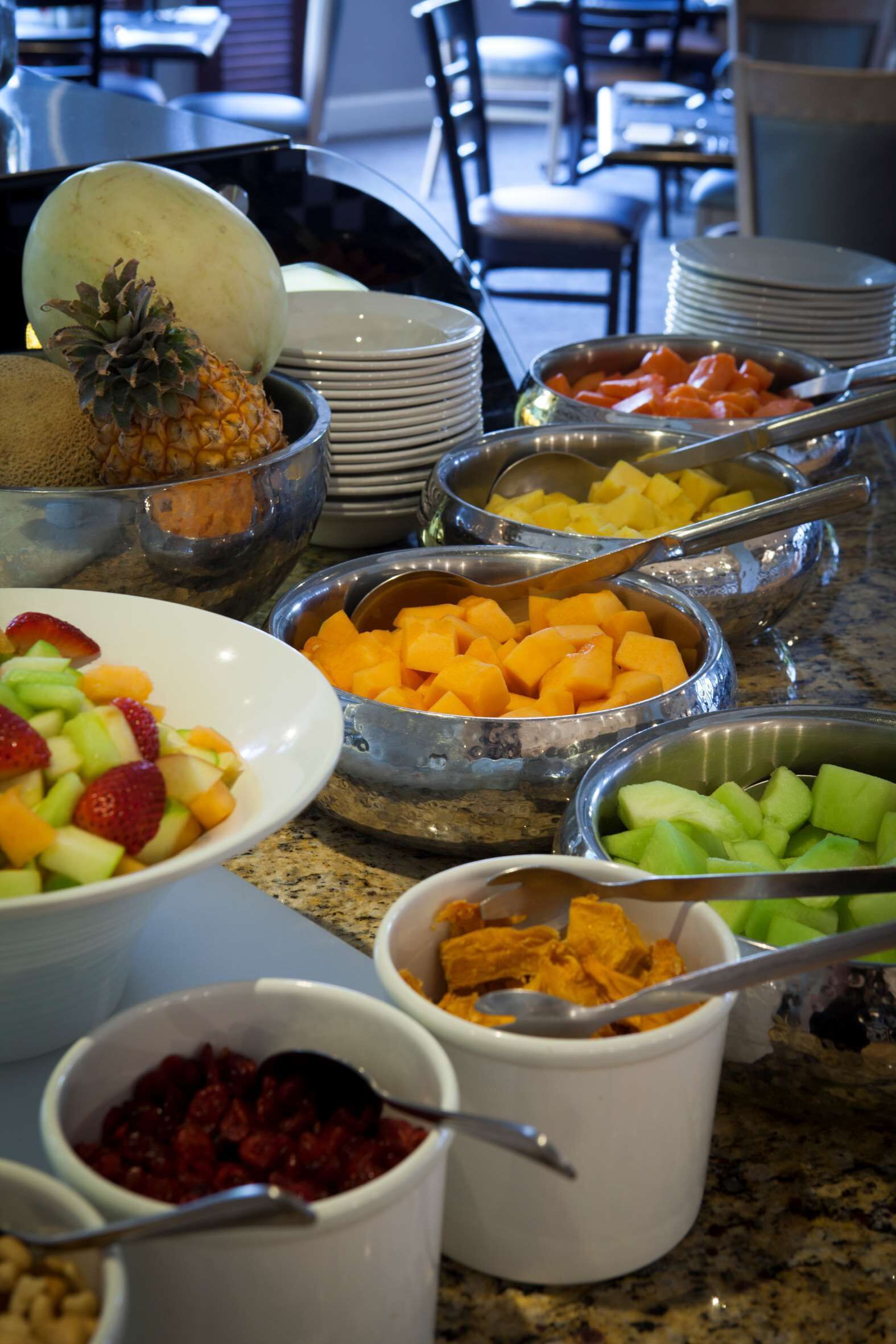 A buffet with various fruits and vegetables.