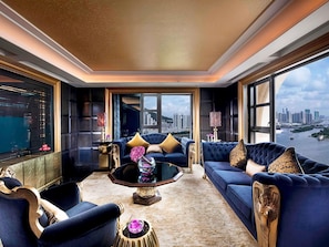 A luxurious living room with a city view, a large sofa, a coffee table, and elegant decor. - Sofitel Macau At Ponte 16 (Macau)