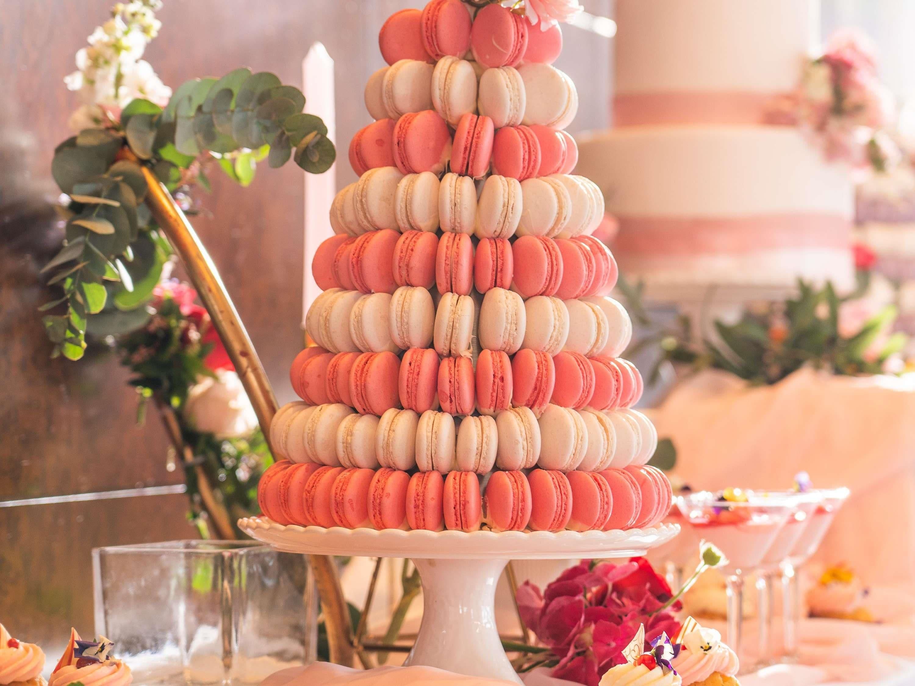 A tiered macaron tower on a white pedestal.
