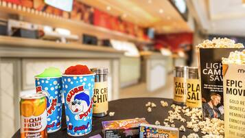 A snack bar with various food items including popcorn, candy, and drinks.