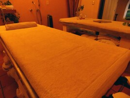 A room with a single bed, a small table, and a chair.