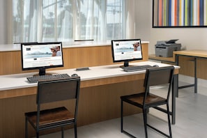 A reception desk with two computer monitors, a keyboard, and two chairs. - Holiday Inn Express Jacksonville Beach by IHG (Jacksonville Beach)