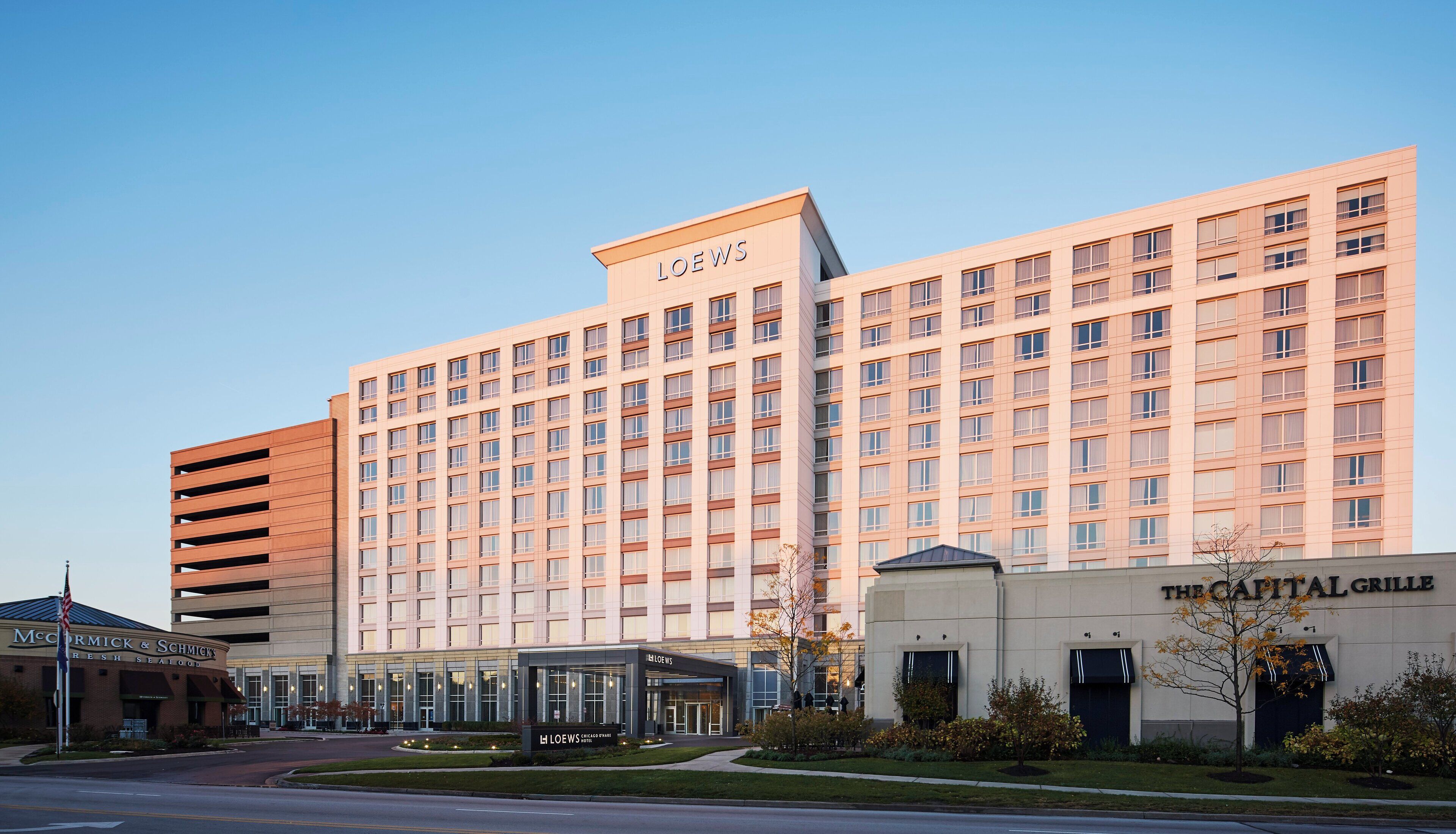 A large hotel building with multiple floors, a prominent 'LOEWS' sign on the top, and a 'THE CAPITAL GRILLE' restaurant at the base.