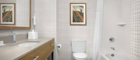 Une salle de bain avec des toilettes, un lavabo et une baignoire.