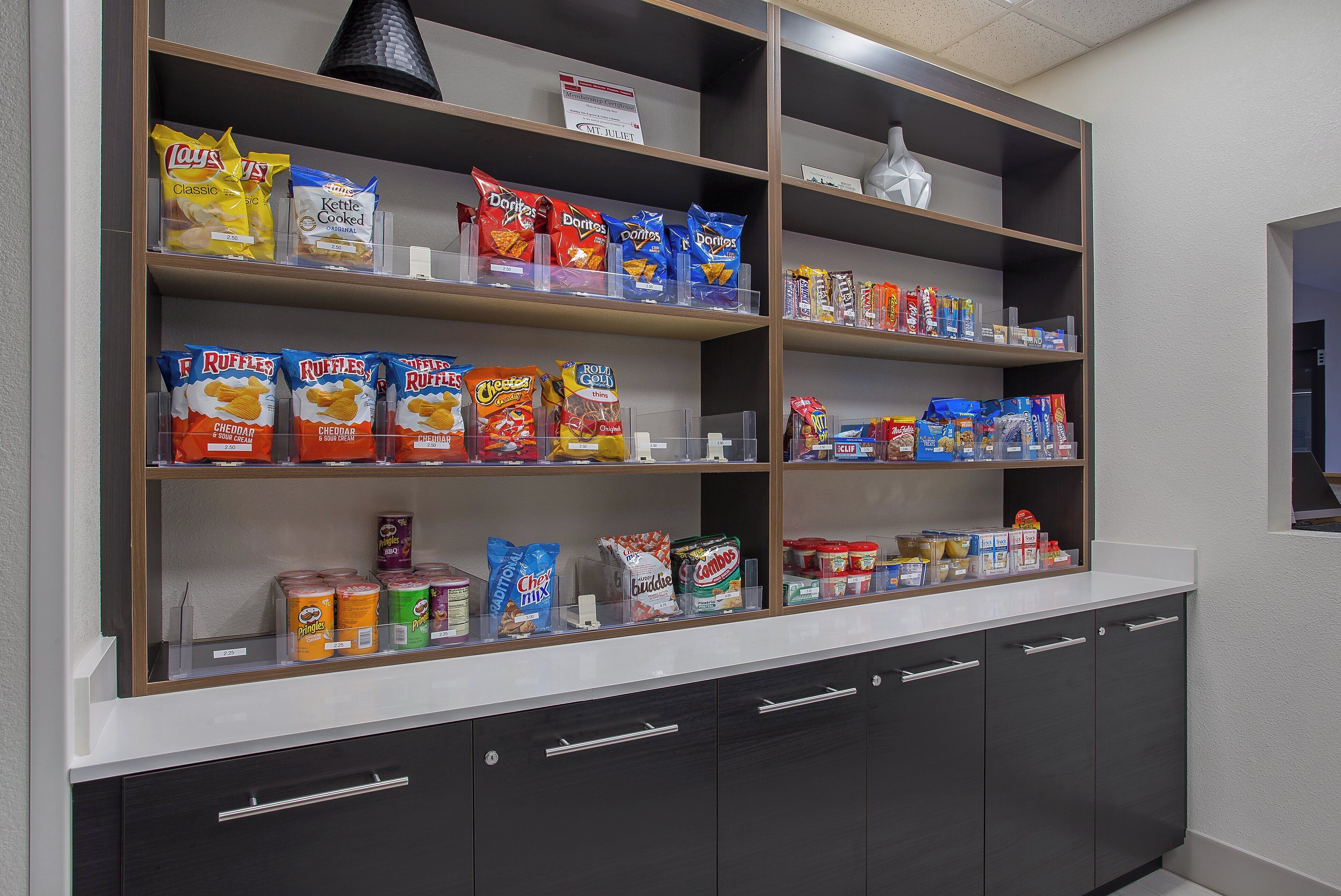 A snack display with various brands and prices.